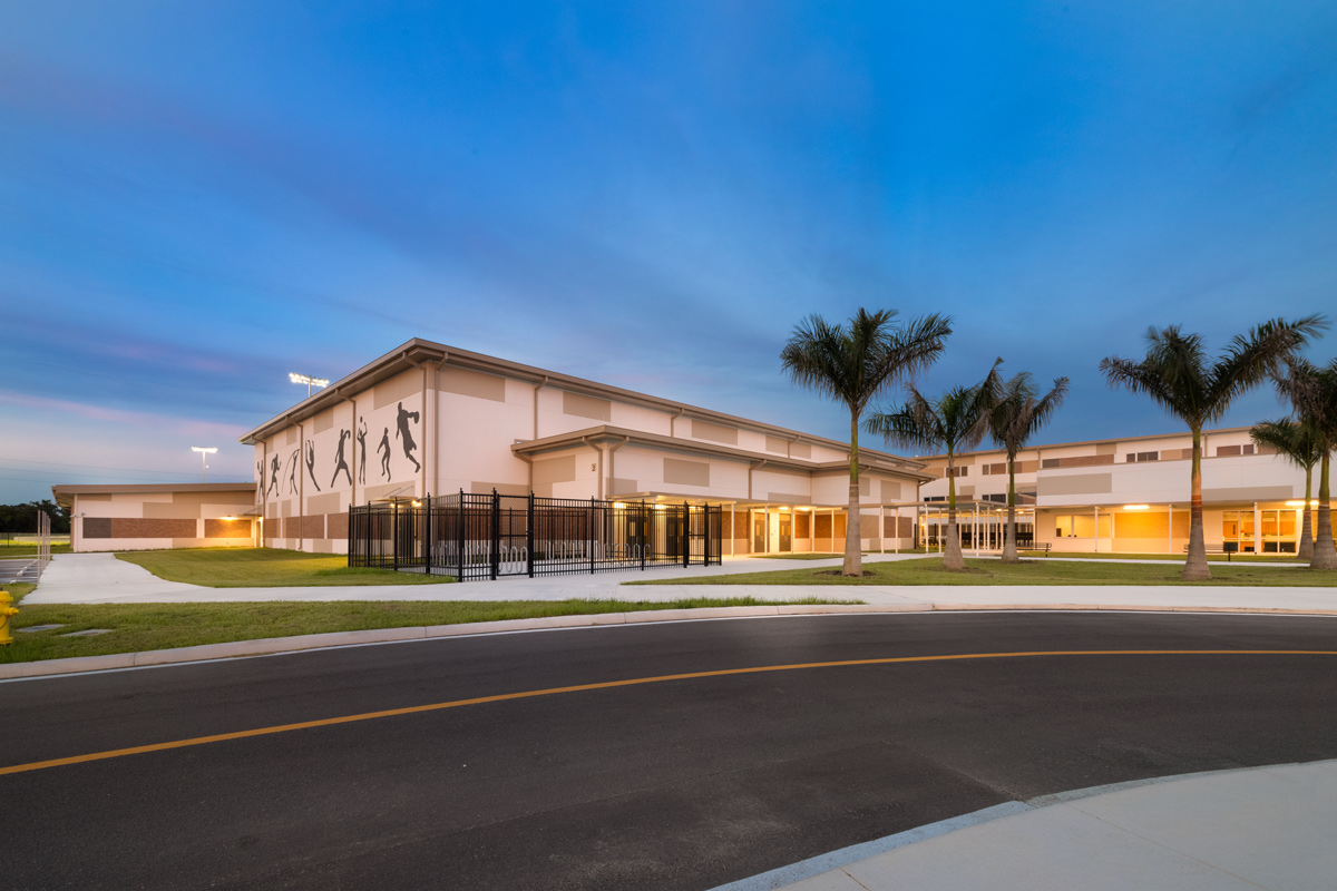 Architectural dusk view of the Gateway High School gym building in Fort Myers, FL.